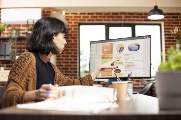 Female analyst review data on computer