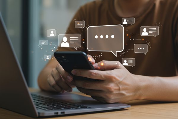 man-using-mobile-phone-laptop-online-communication